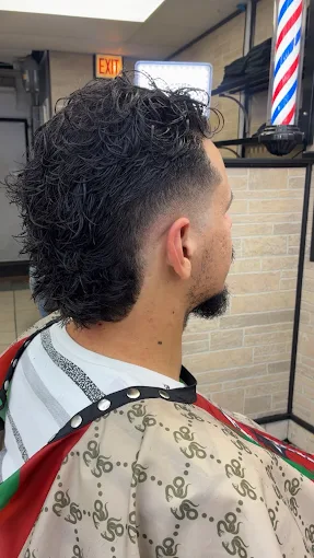 Curly top with a blended mid fade, cut by Jay
